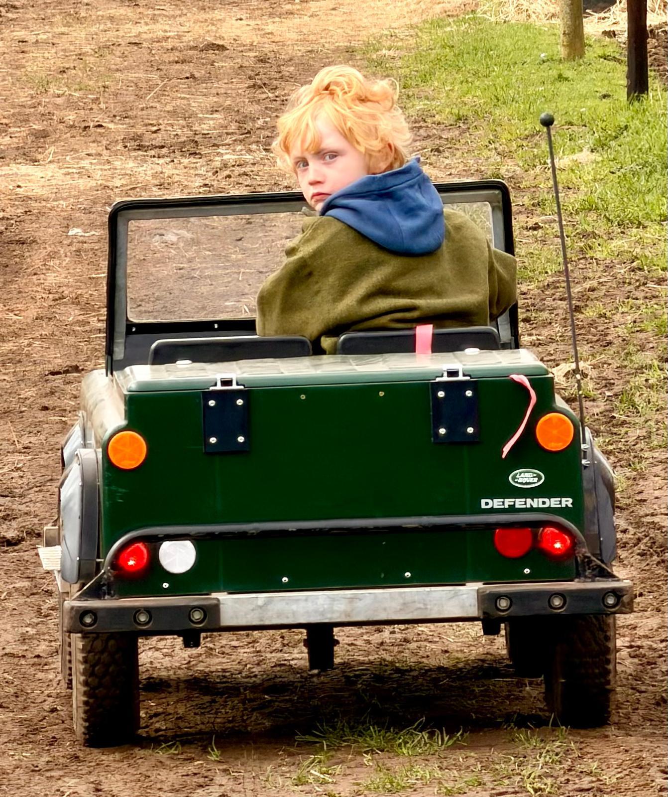 A young driver at the wheel on the off-road track
